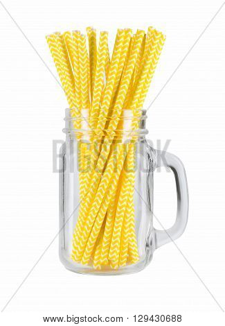 Yellow striped paper straws in mason jar isolated on white background.