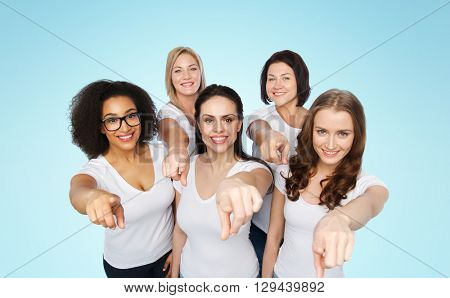 choice, friendship, body positive, gesture and people concept - group of happy different size women in white t-shirts pointing finger on you over blue background