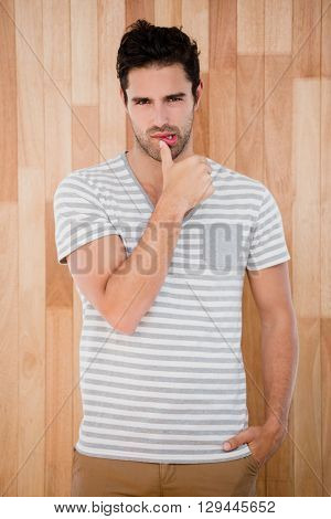 Portrait of handsome man posing in front of wooden background