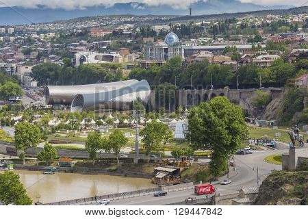 Tbilisi, Georgia - May 07, 2016: People In Apark In Front Of Concert Hall And The Official Residence