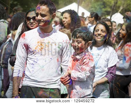 NEW YORK - APR 30 2016: A family celebrates Holi Hai Festival of Colors with colorful powder on their faces in Dag Hammerskjold Plaza hosted by NYC Bhangra in New York on April 30, 2016.