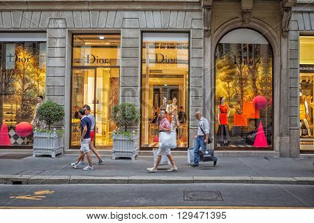 Milan, Italy - Circa August 2013: People walking near fashion Dior stores in Milan.