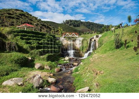 Artificial waterfall with blue sky in Cameron Highlands Malaysia.