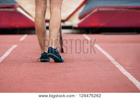 Pole vaulter prepares for jump,looking from behind