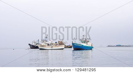 Paracas - Peru October 15 2014: View of a group of anchored fisher boats in a cloudy morning in Paracas Peru