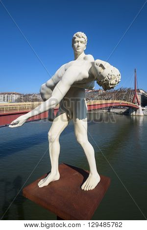 LYON FRANCE - MARCH 18: The weight of One Self sculpture by Michael Elmgreen and Ingar Dragset in the front of Bridge of the Palace of Justice in Lyon on March 18 2016.