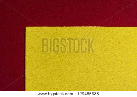 Eva foam ethylene vinyl acetate lemon yellow surface on red sponge plush background