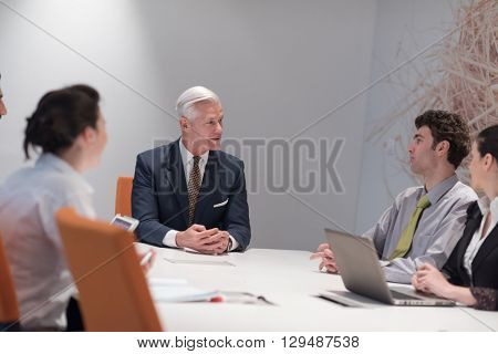business people group brainstorming on meeting and businessman presenting ideas and projects oon laptop and tablet computer