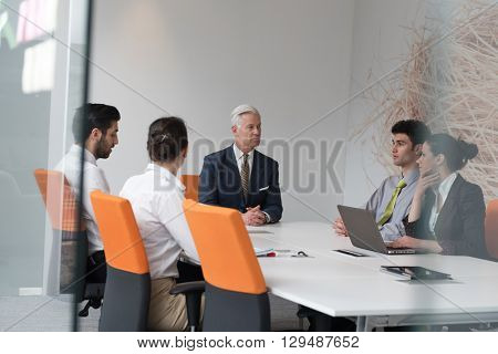 business people group brainstorming on meeting and businessman presenting ideas and projects oon laptop and tablet computer