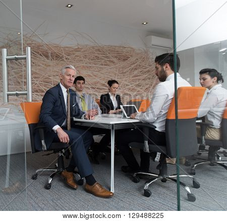 business people group brainstorming on meeting and businessman presenting ideas and projects oon laptop and tablet computer