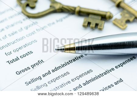 Blue ballpoint pen on an incorporation's income statement waiting for a financial Assistant Vice President (AVP) to review before submission to Chief Executive Officer (CEO). Financial concept.
