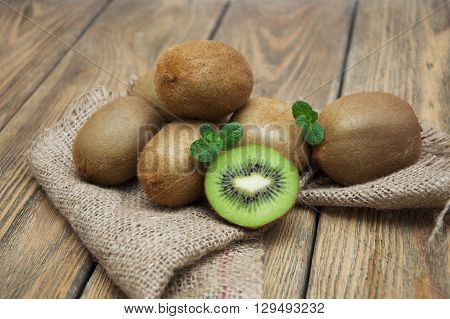 Fresh juicy ripe kiwi on a wooden background