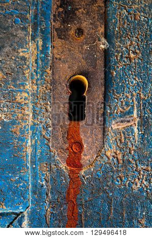 Red blood trace leak out of scary door keyhole burglary criminal murder metaphor