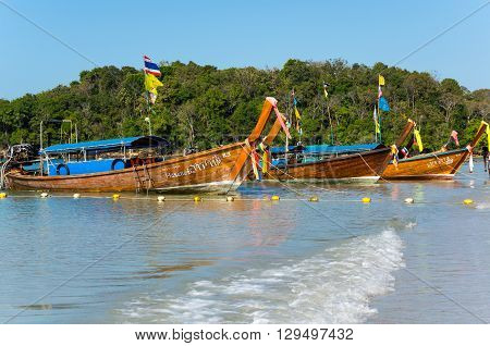 CRABI PROVINCE THAILAND - FEBRUARY 04 2015: Traditional thai long tail boats waiting for tourists to travel to beautiful islands in Thailand