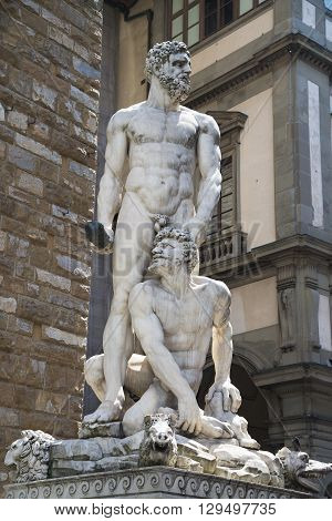 Hercules & Cacus statue on the background of "Palazzo Vecchio" in "Piazza della Signoria" in Florence
