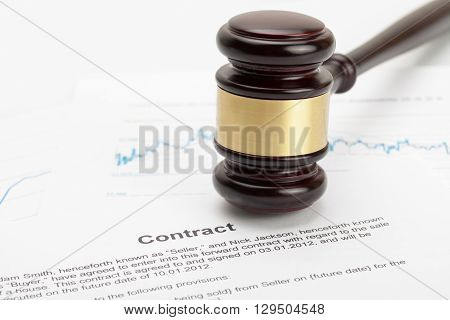 Wooden Judge's Gavel And Calculator Over Some Financial Documents