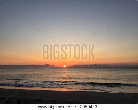 The sun peaking out of the ocean in Boca Raton, Florida.