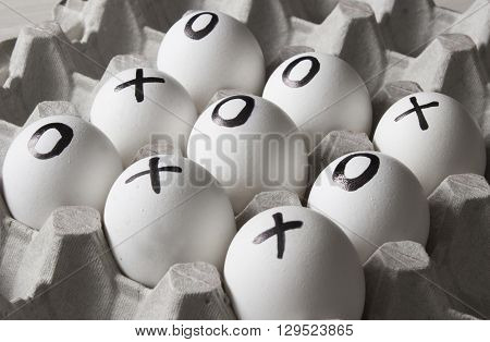 draw. Drawing on white eggs - tic-tac-toe game