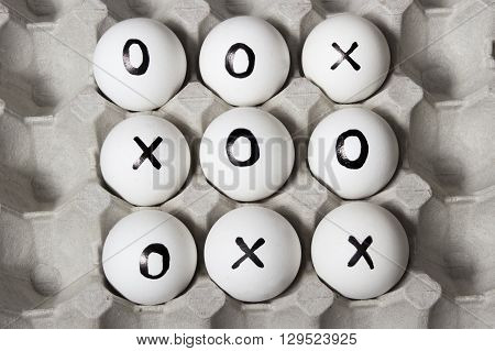 draw. Drawing on white eggs - tic-tac-toe game