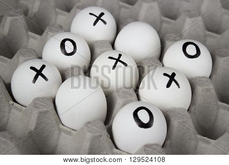 draw. Drawing white  on eggs - tic-tac-toe game