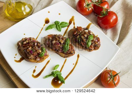 bruschetta with tomato and basil on wooden table