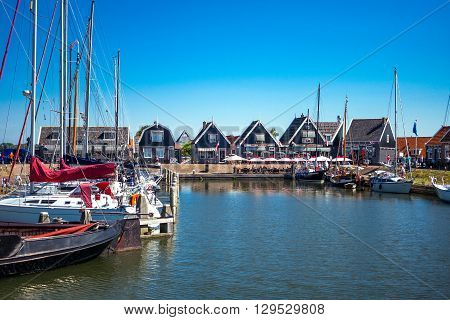 Marken Holland - July 24 2014: Waterland district people and boats in the little harbour