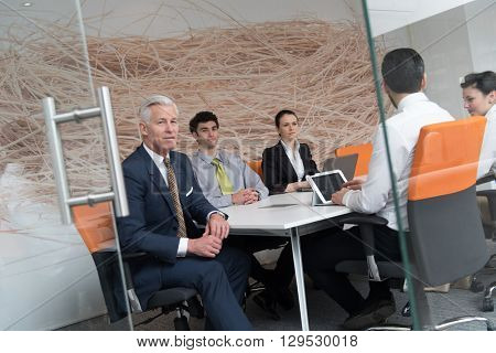 business people group brainstorming on meeting and businessman presenting ideas and projects oon laptop and tablet computer