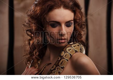 Sexy Brunette Girl With Orange Python Around Her Neck