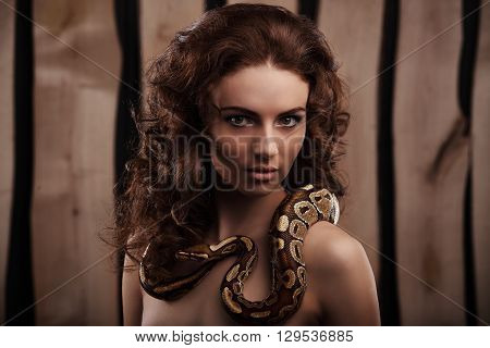 Sexy Brunette Girl With Orange Python Around Her Neck