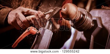 Woodturners Using A Rotating Clamp To Turn The Wood.