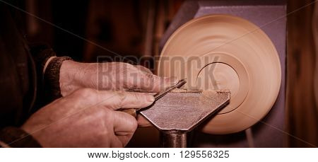 Woodturners Using A Rotating Clamp To Turn The Wood.