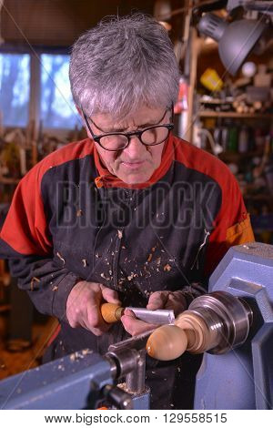 Woodturners Using A Rotating Clamp To Turn The Wood.