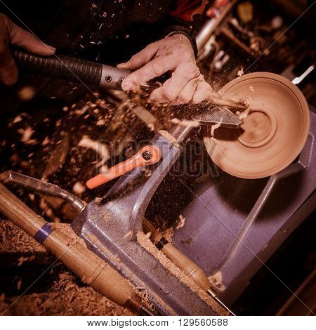 Woodturners Using A Rotating Clamp To Turn The Wood.