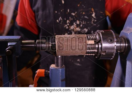 Woodturners Using A Rotating Clamp To Turn The Wood.