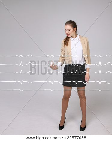 Doctor woman working with cardiogram lines