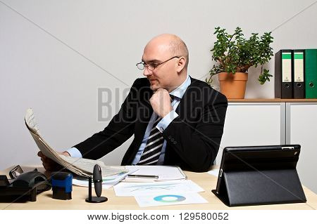 Manager studied the share prices. He is focused.