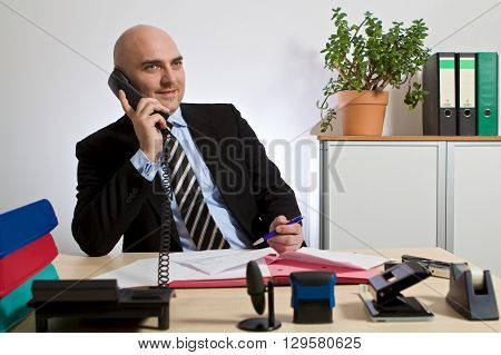 Consultant phoning with customers. He is focused