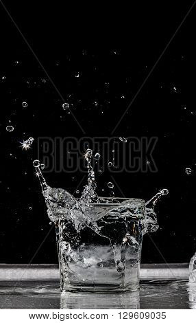 water splash in glass on black background