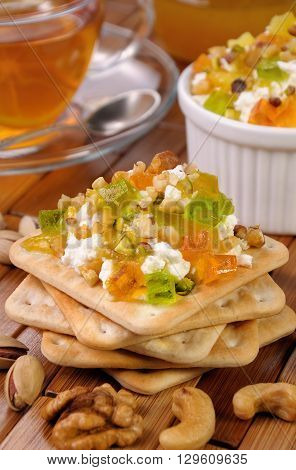 portion of cottage cheese with jam and marmalade nuts on a cracker