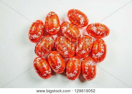 KILCHBERG SWITZERLAND - MARCH 20 2014: Multiple Lindt Lindor chocolate truffle easter egg chocolates on white. Lindt is one one of the lastgest luxury chocolate and confectionery company worldwide with more than 30 factories worldwide