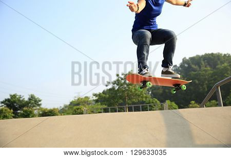 young skateboarder skateboarding at outdoor skate park