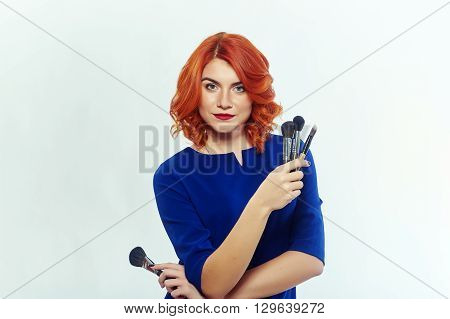portrait of a young girl with a cosmetic brush