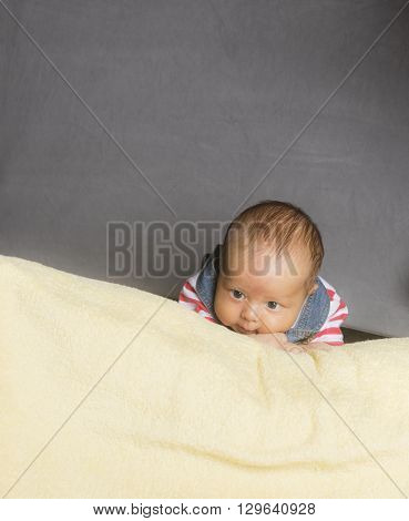 New Born baby on his towl isloated inside studio