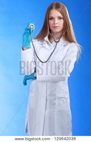 Women attractive doctor isolated over blue background