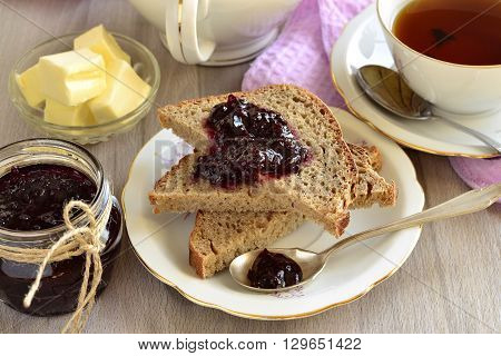 Wholegrain toast with blackcurrant jam and butter