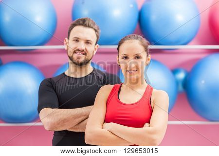 Portrait of a fit couple in a gym. Slective focus on the woman with braces.