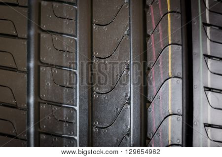 Car tires close-up Winter wheel profile structure on black background
