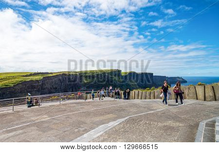Calway Ireland - August 4 2013: Visitors in the Cliffs of Moher look out at the cliffs