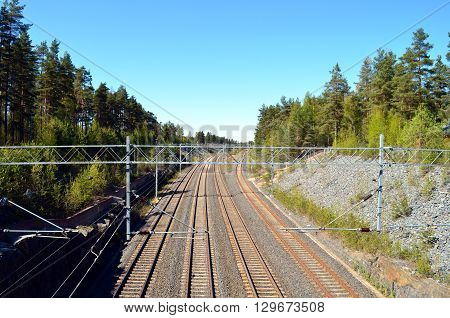 view onto a rails in finnland with blue sky