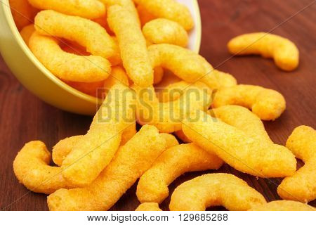 Cheese snacks closeup on red wooden table